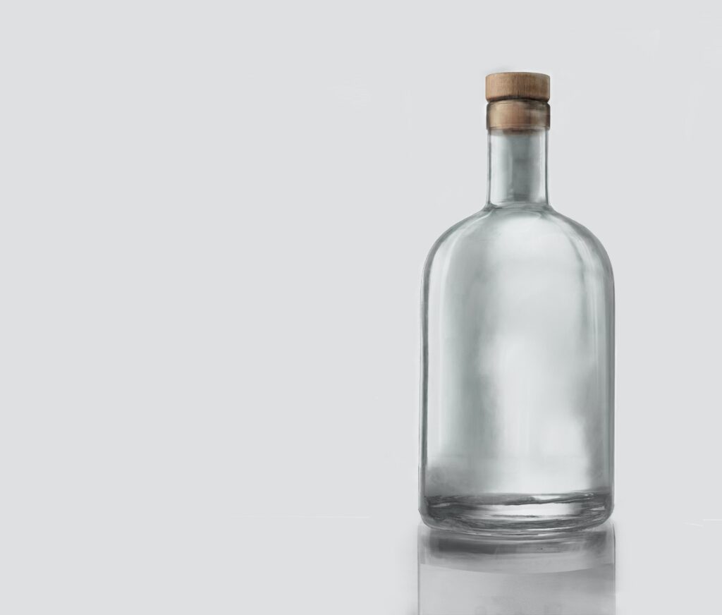 Empty glass bottle with a cork in it.