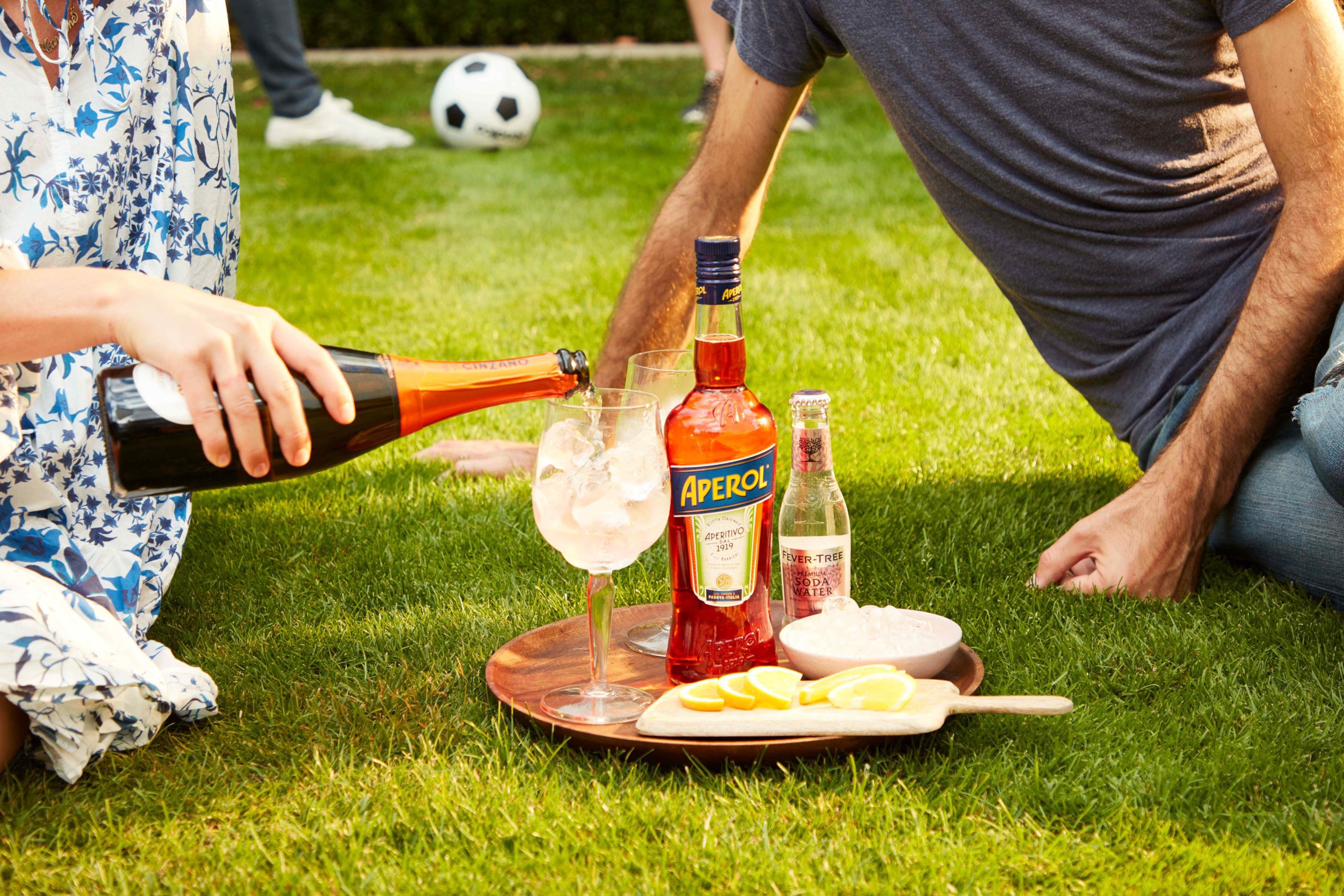 Out Of Home billboard advert by YesMore spirits Marketing Agency for Aperol Spritz showing a couple having a picnic making an Aperol Spritz on the grass