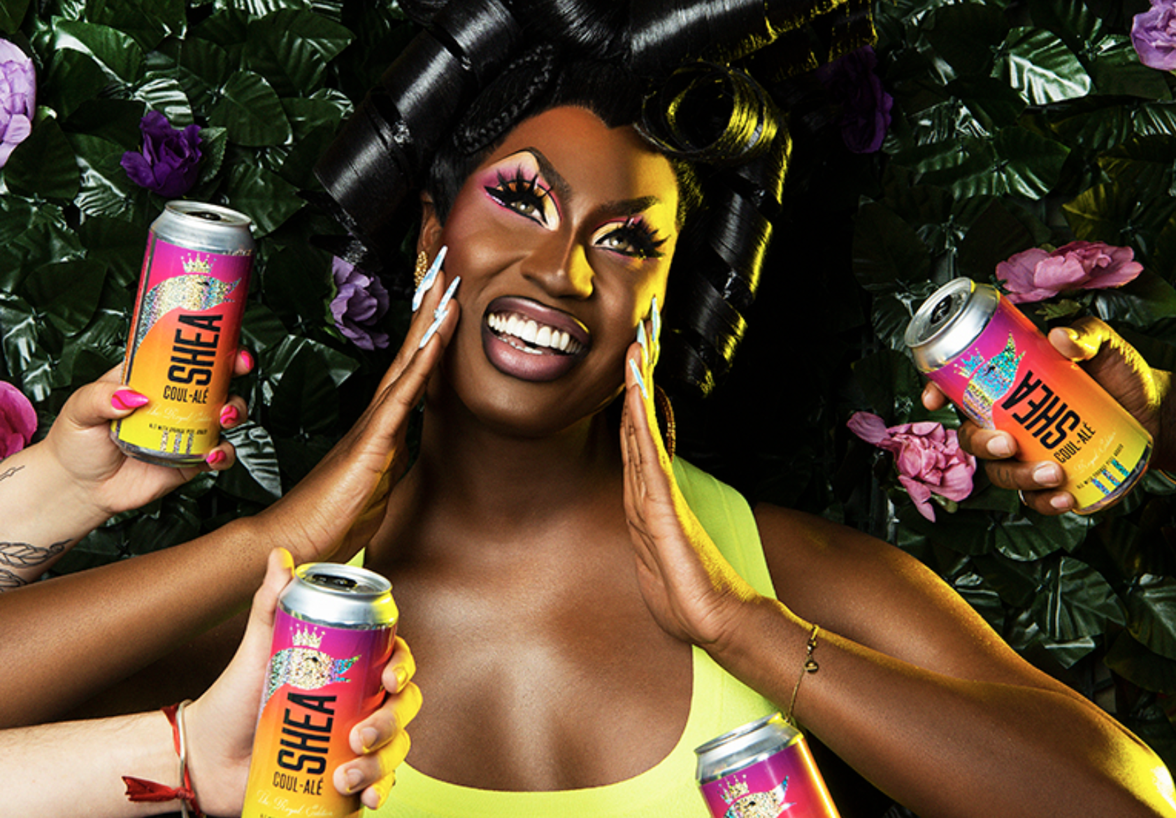 Drag queen Shea Couleé poses with beer cans 